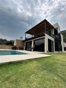 a house with a swimming pool in front of it at Dalusa House in Tena