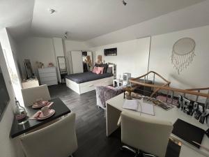 a living room with a bed and a table and chairs at La Vie est Belle chambre d hôte in Verviers