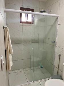 a shower with a glass door in a bathroom at Refúgio do Mar in Nísia Floresta