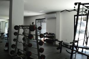 a gym with a bunch of equipment in a room at The Residences Apart-Hotel By Morgan in Cabo San Lucas