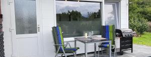 a patio with a table and chairs and a grill at Huus-Weitblick an der Weser in Polle