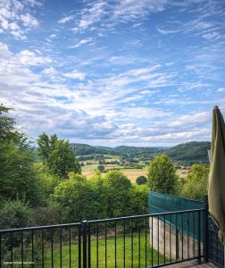 a balcony with a view of a field and trees at Huus-Weitblick an der Weser in Polle