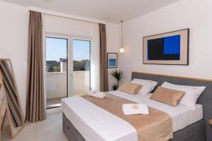a bedroom with a large bed and a large window at NEW! Villa Rabella - Luxury Oasis, Island Rab in Rab +36 photos