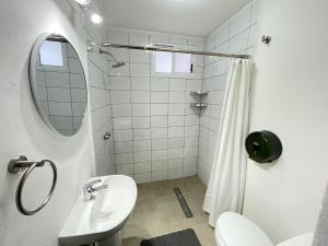 a white bathroom with a sink and a mirror at The Boat House Cancun in Cancún +55 photos