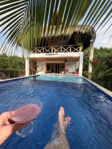 a person in a swimming pool with a bowl of sand at Cabaña CasaMar Angelica in El Puertón