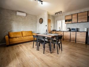 a kitchen with a table and chairs and a couch at Perła Turawa in Turawa
