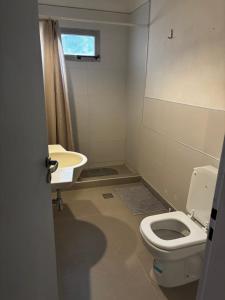 a bathroom with a toilet and a sink at PataGo! Sea&Sand in Playa Unión