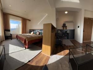 a bedroom with a bed and a desk in a room at Cho Suites in Leh