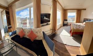 a living room with a couch and a large window at Cho Suites in Leh