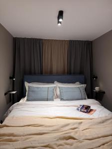 a bedroom with a large bed with a blue headboard at The 9 loft in Pyrgos