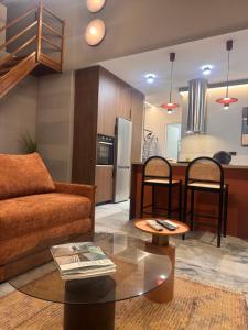 a living room with a couch and a table at The 9 loft in Pyrgos
