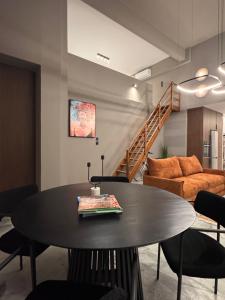 a living room with a table and a couch at The 9 loft in Pyrgos