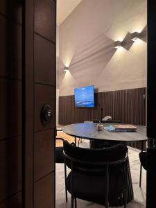 a dining room with a table and a tv at The 9 loft in Pyrgos +15 photos