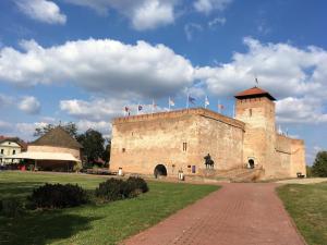 a large castle with flags on top of it at AIDA Apartman in Gyula