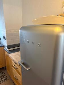 a stainless steel refrigerator in a kitchen at La maisonnette LMV in Sanary-sur-Mer +1 photo