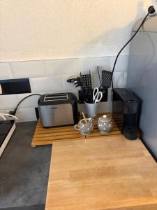 a kitchen with a counter with a toaster and a microwave at La maisonnette LMV in Sanary-sur-Mer