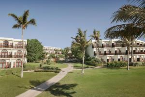a resort with palm trees and a pathway at JA Palm Tree Court, Dubai in Dubai