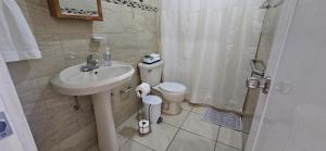 a bathroom with a sink and a toilet and a shower at Casita Playera Aguadeña in Tablonal