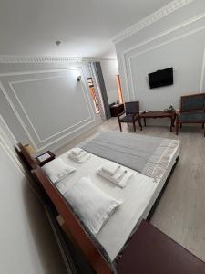 a bedroom with a bed with towels on it at SHoxtut INN 18-19Th Century in Bukhara +29 photos