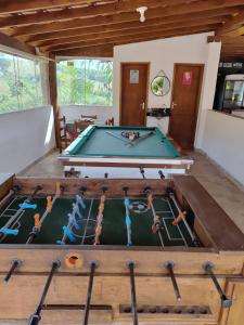 a pool table in the middle of a room at Pousada irmãos Oliveira in Lindóia
