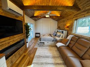 a living room with a couch and a bed at Eagle’s Landing Lodge in Custer