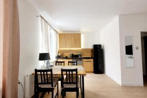 a kitchen with a table and chairs in a room at Przystanek Sudety in Wałbrzych