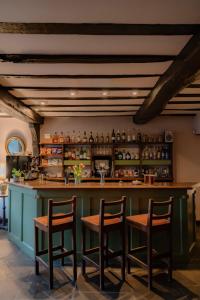 a bar with two chairs and a counter at The Wensleydale Hotel in Middleham