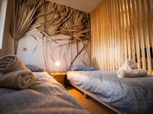 a bedroom with two beds with towels on them at Perła Turawa in Turawa