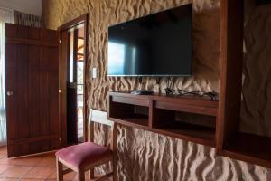 a living room with a television on a wall at Villa Germana in Paipa