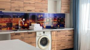 a kitchen with a washing machine in a kitchen at Cozy Almaty Escape in Almaty