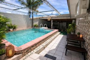 a swimming pool in a patio with a table and chairs at La Baraka in Dzaoudzi