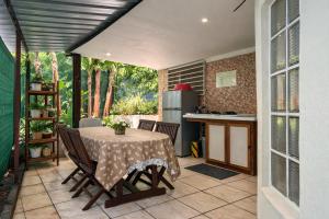 a kitchen with a table with chairs and a kitchen with a tableablish at La Baraka in Dzaoudzi