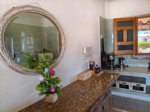 a kitchen with a mirror and a christmas tree on a counter at Casa Punta Perula Boutique Hotel in Pérula