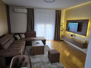 a living room with a couch and a table at ENA Lux in Novi Pazar