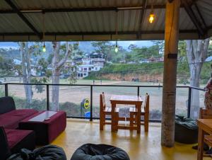a living room with a table and a couch at Rich Grove Inn in Ella