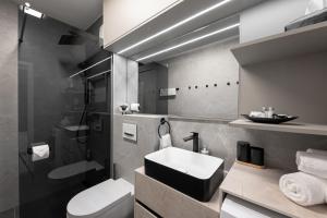 a bathroom with a sink and a toilet and a shower at Sunshine Breeze in Promajna +166 photos
