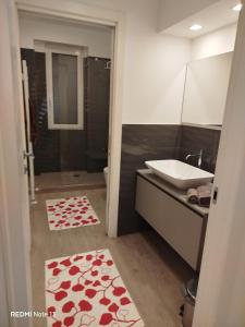a bathroom with a sink and a toilet and a shower at La casa dell'orsetta in Loano