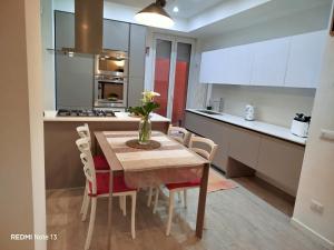 a kitchen and dining room with a table and chairs at La casa dell'orsetta in Loano