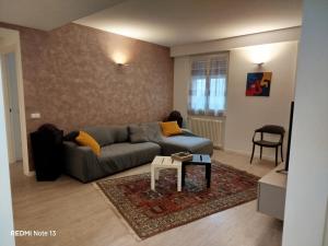 a living room with a couch and a table at La casa dell'orsetta in Loano