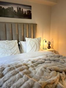 a bedroom with a large bed with a blanket at Beachside Bliss Gordons Bay in Gordonʼs Bay +13 photos