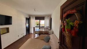 a living room with a couch and a table at 203 Barra Refúgio in Tramandaí