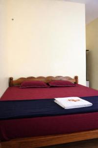 a bedroom with a bed with a red and blue blanket at Kudle Heaven in Gokarna