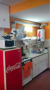 a coca cola refrigerator in a kitchen with a counter at San bernardo edificio frente al mar in San Bernardo