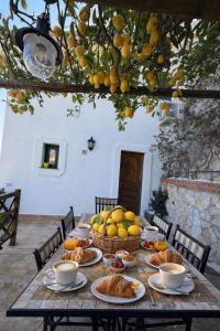 a table with a bunch of bread and fruit on it at Villa Degli Ulivi in Furore