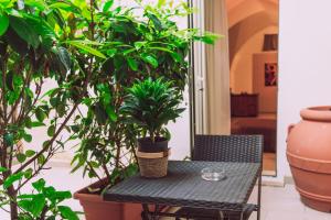 a black table with plants on a patio at Afrodite suite room in Brindisi