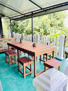 a wooden table and benches on a patio at Kandy Green HillTop Hotel in Kandy