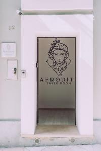 a door into a white room with a sign at Afrodite suite room in Brindisi