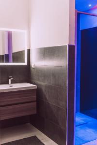 a bathroom with a sink and a shower at Afrodite suite room in Brindisi