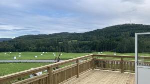 a balcony with a view of a field with sheep at Maple Cottage in Docksta