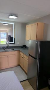 a kitchen with a stainless steel refrigerator and a sink at Days Inn by Wyndham Paducah I-24 Exit 4 in Paducah +13 photos